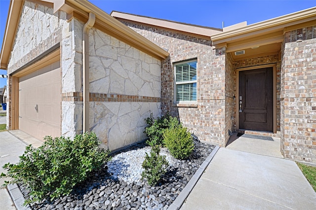 view of exterior entry with a garage