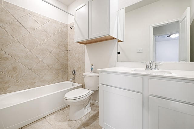 full bathroom featuring tiled shower / bath, vanity, toilet, and tile patterned flooring