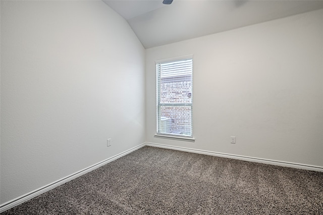 spare room featuring carpet and lofted ceiling