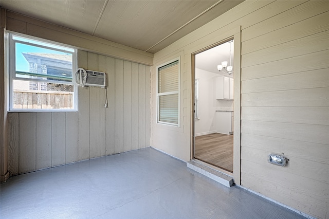 unfurnished sunroom featuring a wall mounted AC