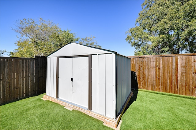 view of outbuilding with a lawn