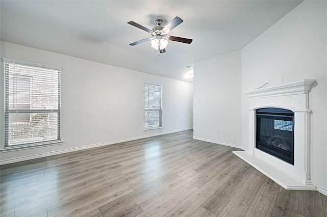 unfurnished living room with light hardwood / wood-style floors and ceiling fan