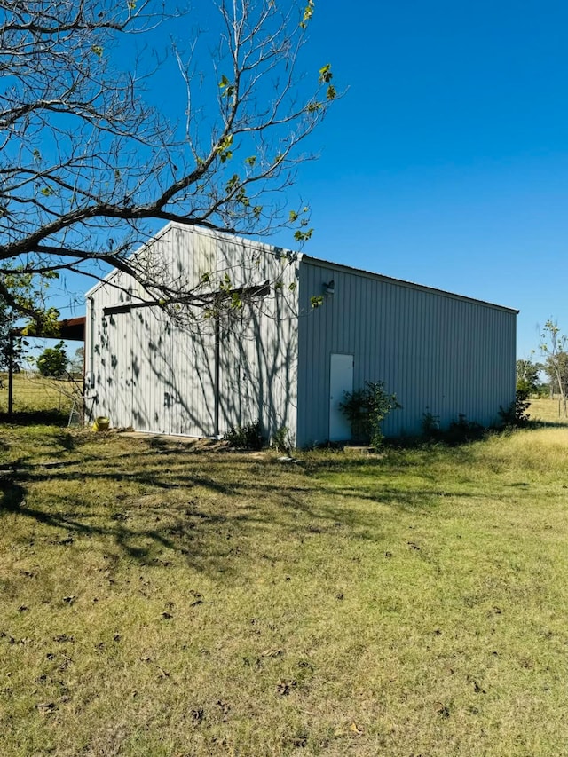 view of outbuilding featuring a yard