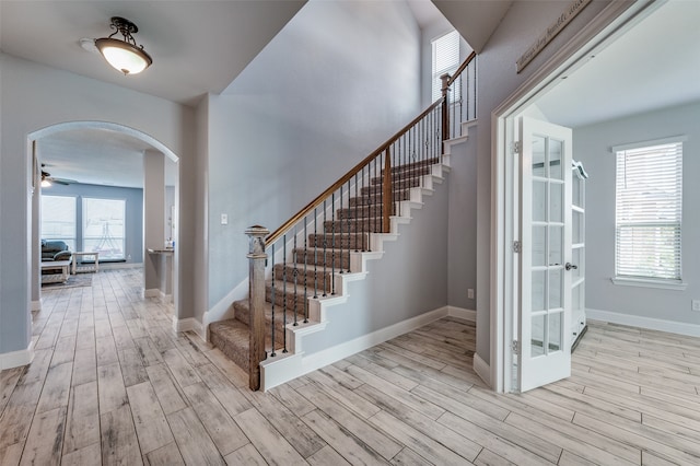 foyer entrance with light hardwood / wood-style flooring and ceiling fan