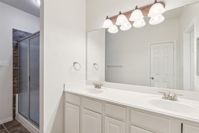 bathroom with vanity, a shower with shower door, and tile patterned flooring