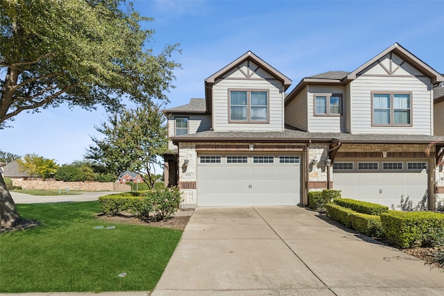 view of front of home with a garage and a front lawn