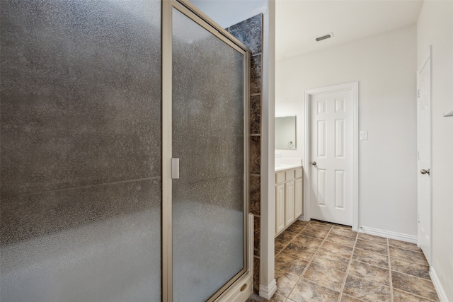 bathroom featuring vanity and a shower with shower door