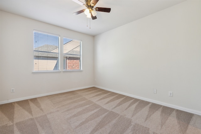 spare room featuring light carpet and ceiling fan