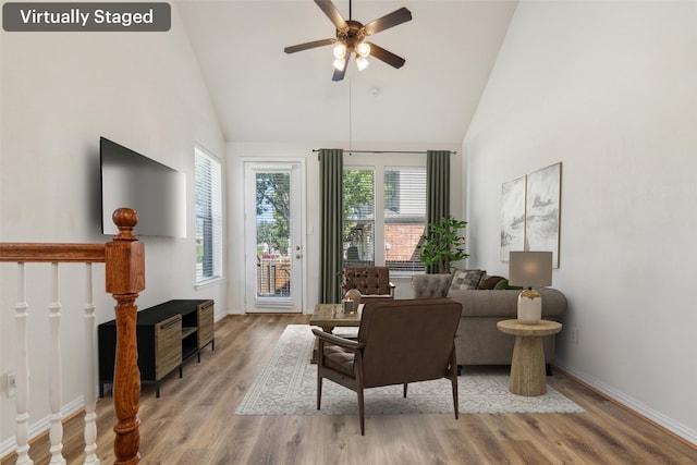 living room with high vaulted ceiling, light hardwood / wood-style floors, and ceiling fan