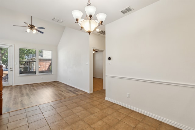 unfurnished room with vaulted ceiling, ceiling fan with notable chandelier, and light hardwood / wood-style floors