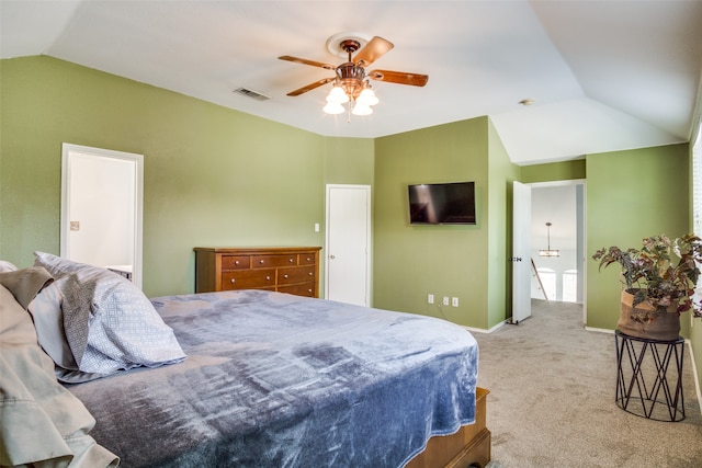 carpeted living room with ceiling fan and vaulted ceiling