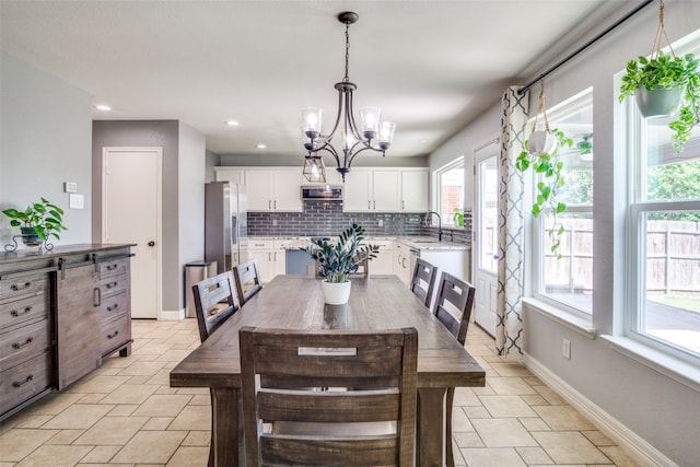 dining area featuring an inviting chandelier and sink