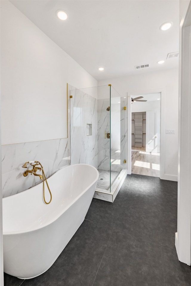 bathroom with plus walk in shower and tile patterned flooring