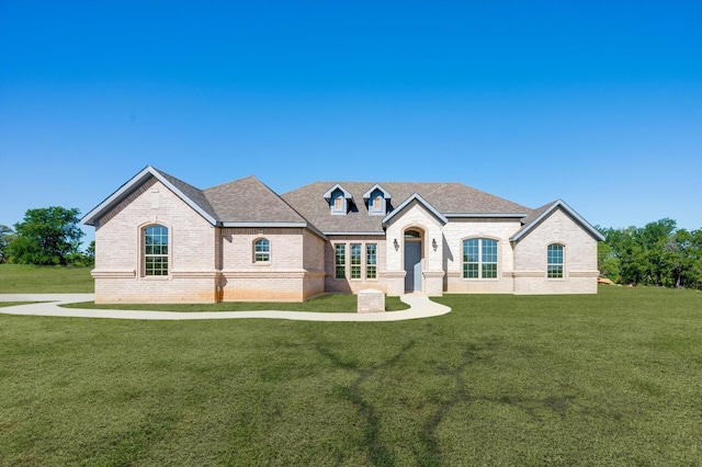 french provincial home featuring a front lawn