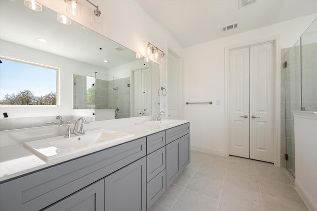 bathroom featuring vanity, tile patterned flooring, and an enclosed shower