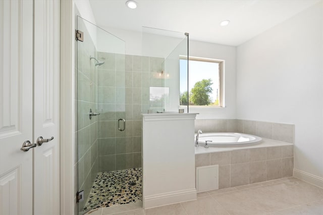 bathroom featuring separate shower and tub and tile patterned flooring