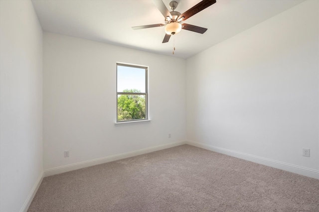 unfurnished room with ceiling fan and carpet