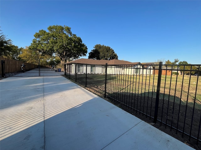 view of gate with a lawn