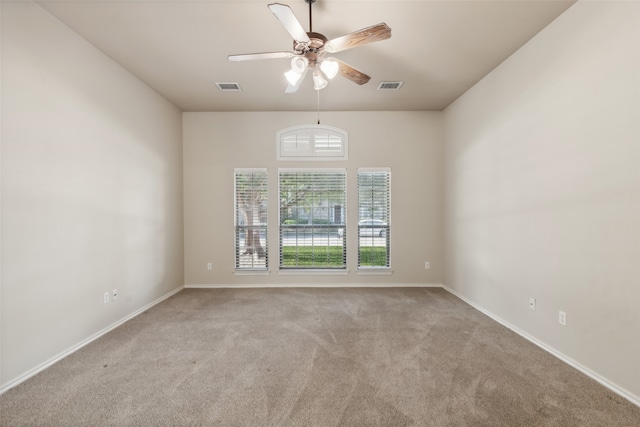 empty room with light colored carpet and ceiling fan