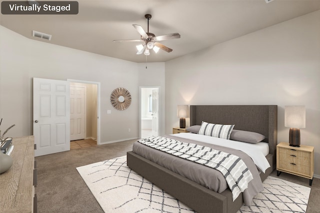 carpeted bedroom with connected bathroom and ceiling fan