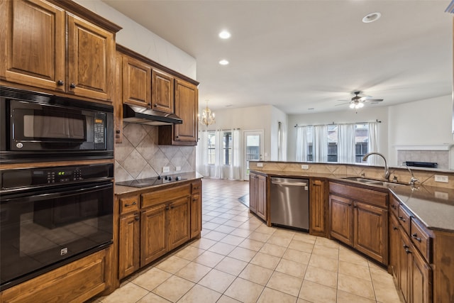 kitchen with a wealth of natural light, sink, black appliances, and ceiling fan with notable chandelier