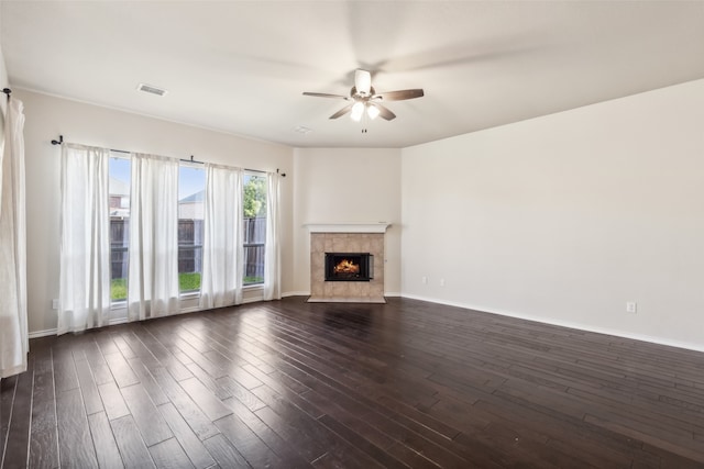 unfurnished living room featuring ceiling fan and dark hardwood / wood-style flooring