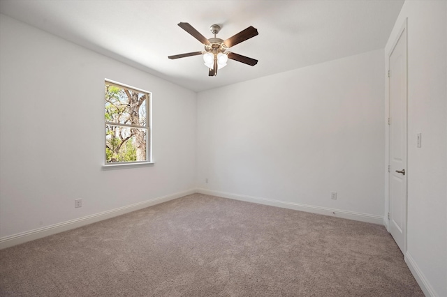 unfurnished room featuring ceiling fan and carpet flooring