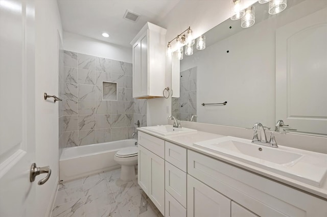 full bathroom with vanity, tiled shower / bath combo, and toilet