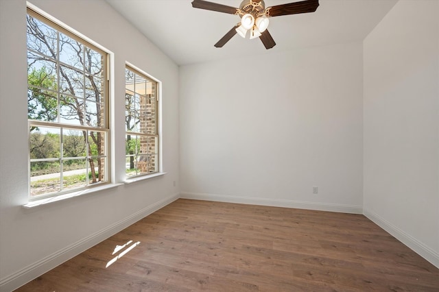 unfurnished room with hardwood / wood-style floors, ceiling fan, and a wealth of natural light