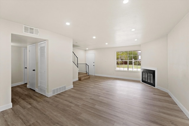 unfurnished living room featuring light hardwood / wood-style floors