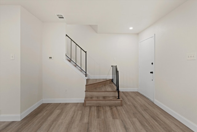 stairs with hardwood / wood-style flooring