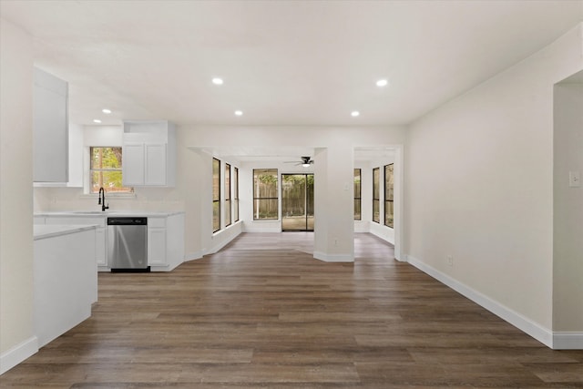 corridor with hardwood / wood-style flooring and sink