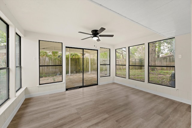 unfurnished sunroom with ceiling fan and plenty of natural light