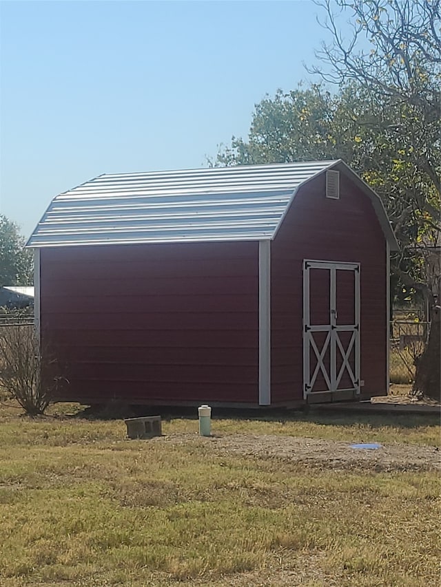 view of outbuilding with a lawn