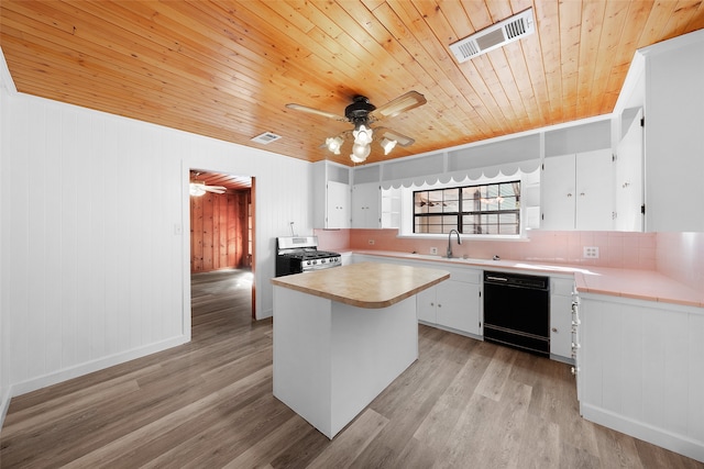 kitchen with gas stove, dishwasher, a center island, light hardwood / wood-style flooring, and white cabinets