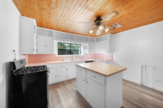 kitchen featuring wooden ceiling, white cabinets, light wood-type flooring, black gas range oven, and a kitchen island