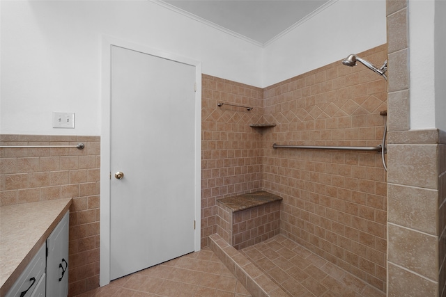 bathroom with tile patterned flooring, vanity, tile walls, and ornamental molding