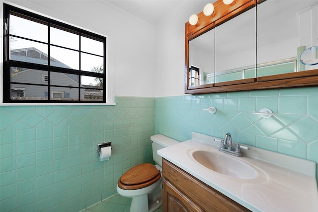 bathroom with tile patterned floors, vanity, toilet, and tile walls