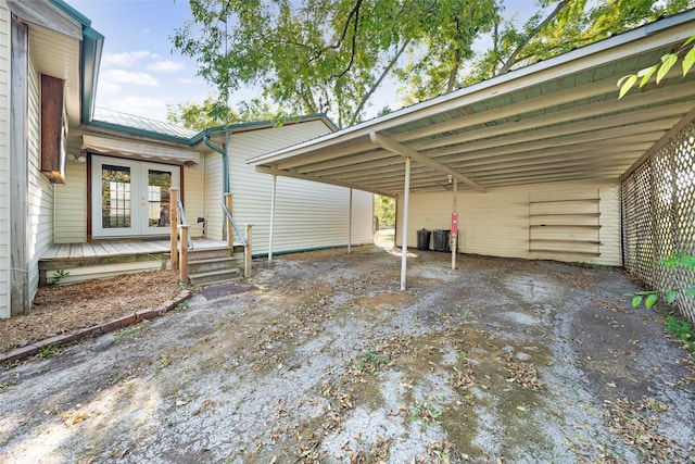 view of vehicle parking featuring a carport and french doors