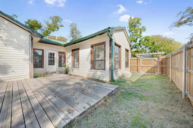 wooden terrace featuring a yard