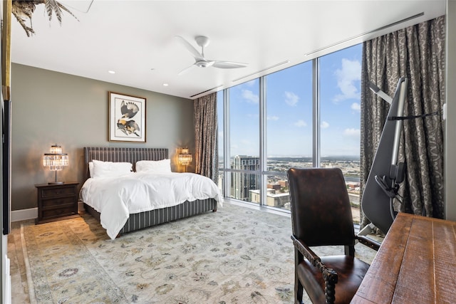 bedroom with ceiling fan and floor to ceiling windows