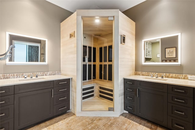 bathroom with vanity and tasteful backsplash