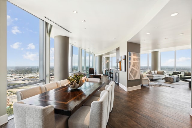 dining area featuring floor to ceiling windows and dark hardwood / wood-style flooring