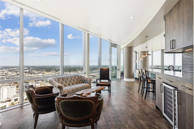 living room featuring expansive windows, beverage cooler, and dark hardwood / wood-style flooring