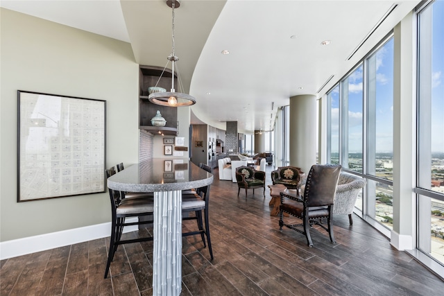 dining room with floor to ceiling windows and dark hardwood / wood-style floors