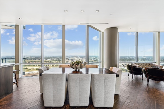 dining room with dark wood-type flooring and a wall of windows