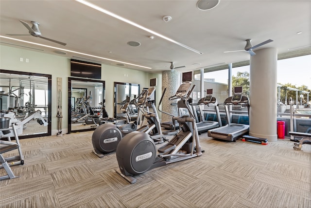 gym featuring light carpet, floor to ceiling windows, and ceiling fan