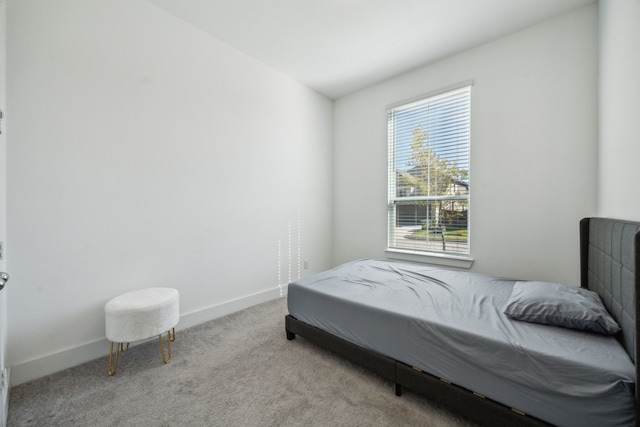 bedroom featuring light carpet