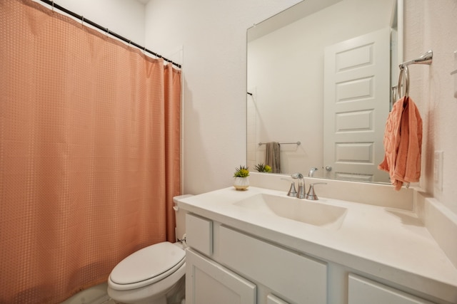 bathroom featuring toilet, vanity, and a shower with shower curtain