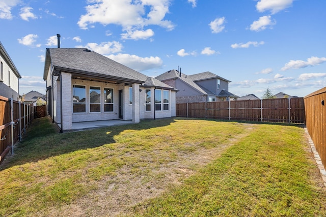 back of house featuring a yard